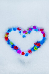 Heart of color gems on snow