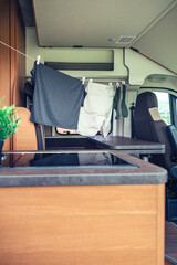 Clothes hanging on a line to dry inside a camper van