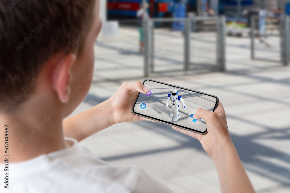 Wall mural boy programs and controls the robot on the street via augmented reality technology concept