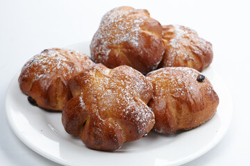 baked sweet buns on the white plate
