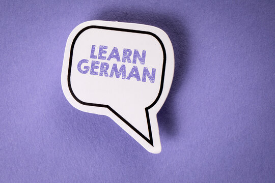 Learn German. White speech bubble on a purple background