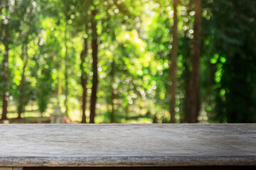 Fototapeta na wymiar Wood table with blurred green bokeh background with copy space