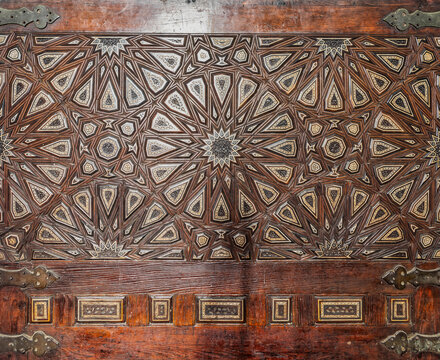 Wooden arabesque decorations tongue and groove assembled, inlaid with ivory and ebony, at Quran reading bench, at historic public Mosque of Al Rifai, Cairo, Egypt