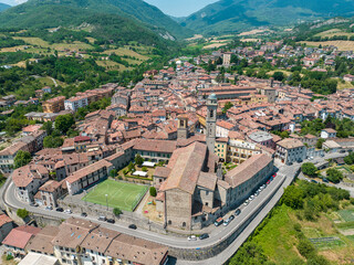 Aerial view of Bobbio, a town on the Trebbia river. Bridge. Piacenza, Emilia-Romagna. Details of the urban complex, roofs and bell towers of the town between the valleys of the Apennines. Italy
 - obrazy, fototapety, plakaty