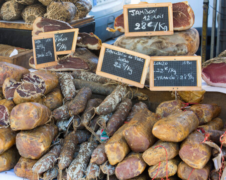 Selection of Corsican sausages and hams for sale at open-air market in Place Foch, Ajaccio, Corse-du-Sud