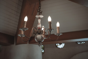 Antique ceramic red rose pattern chandelier lamp lighting bulbs on the ceiling with copy space interior for home and living retro-style building.