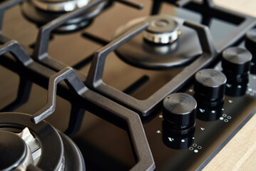 New kitchen stove panel with gas hob, close up. Modern kitchen appliance