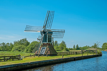 Old traditional windmill in a dutch landcape in Friesland the Netherlands