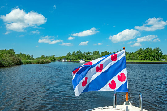 Cruising through National Park Alde Feanen in Friesland the Netherlands with the frisian flag