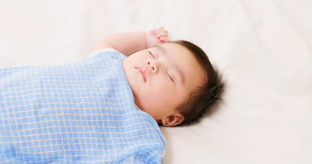 baby sleeping on the bed