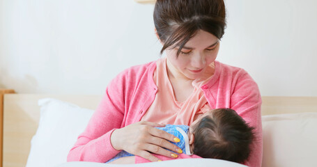 asian mother breastfeeding baby - obrazy, fototapety, plakaty