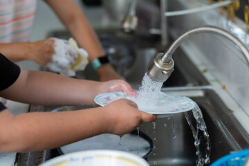 Close up hands washing dishes