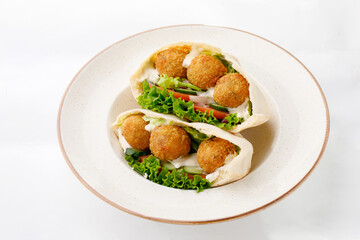 Falafel with chicken rolls and pita on a white background