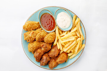 Chicken legs with fries on white background