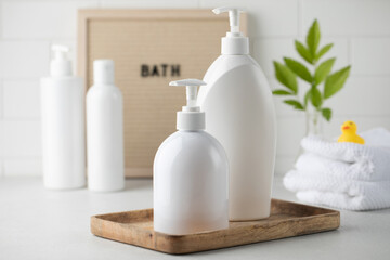 Blank plastic dispenser bottles with soap and shampoo for everyday in bathroom. Toiletries set