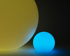 Glowing and illuminated spherical coloured orbs on a black background.