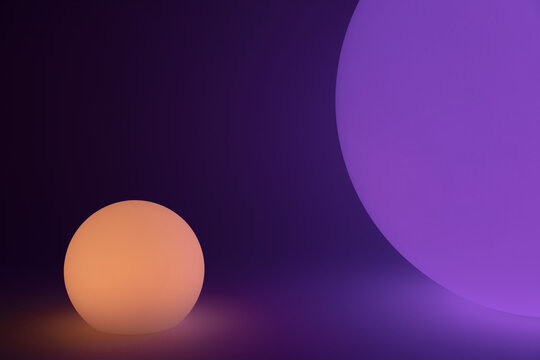 Glowing and illuminated spherical orbs, one large and one small.