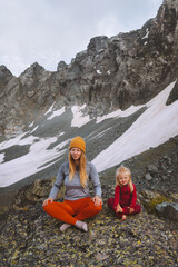 Fototapeta Family mother and daughter outdoor practicing yoga in mountains healthy lifestyle vacations parent and child training together harmony with nature meditation obraz