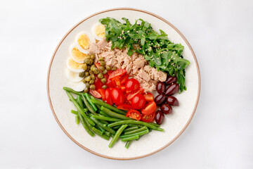 Egg tuna salad with green peas on a white background