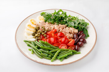 Egg tuna salad with green peas on a white background