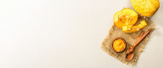 Autumn food cooking concept. Pumpkin puree, whole and cut pumpkins. Traditional fall symbol