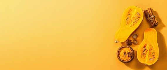 Half of the raw pumpkin with butternut squash puree and spices. Assortment ingredients for cooking