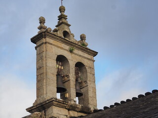 vista posterior del campanario de espadaña de la iglesia de san vicente de los villares,  con dos campanas, base rectangular, construccion en piedra gris, lugo, españa, europa