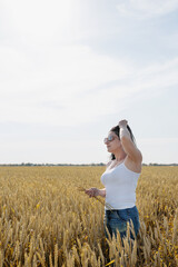 Mid adult woman walking on rye field enjoying nature