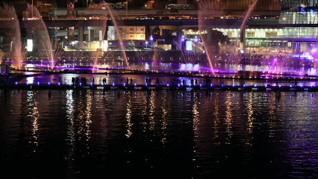 Vivid Sydney Darling Harbour floating fountain time lapse at night as 4k.
