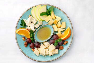 Parmesan cheeses nicely arranged on a plate on a white background