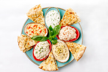 Pita with sauce topping on a white background
