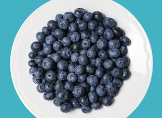 Blueberries fresh on a white plate close-up