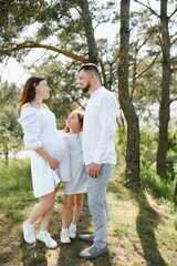 Pregnant woman with her family looking happy