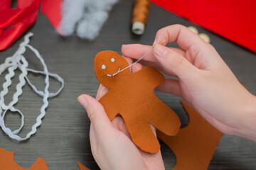 Christmas toy made of felt gingerbread man mouth embroidery. Step-by-step manufacturing instructions