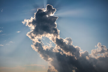 Sky meteorology background, sun rays shining through clouds on blue sky
