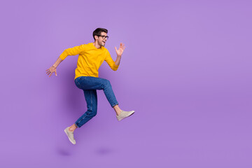 Fototapeta na wymiar Full length image of overjoyed delighted man running fast speed traveling have fun isolated on violet color background