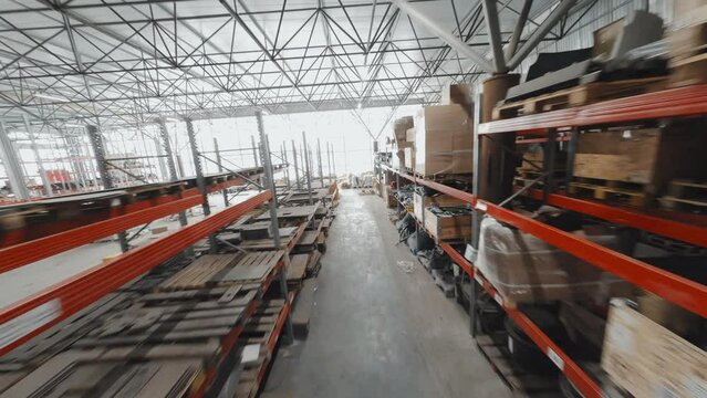 Drone tracking view of storage with heavy machinery parts in afternoon