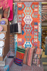 Colorful persian carpets, bags and pillows in market in Turkey