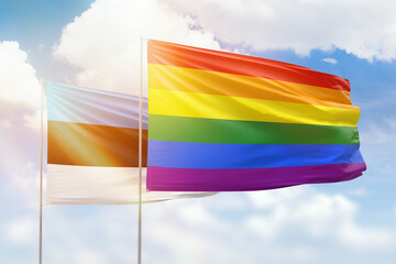 Sunny blue sky and flags of lgbt and estonia