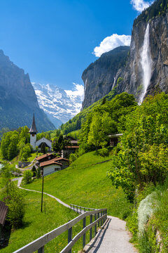 amazing alpine landscape in Lauterbrunnen village with church and waterfall in Switzerland