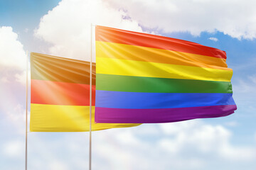 Sunny blue sky and flags of lgbt and germany