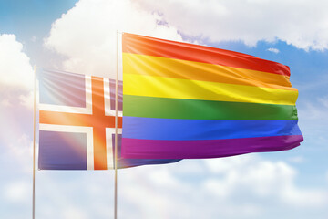 Sunny blue sky and flags of lgbt and iceland