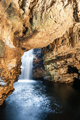 Obraz na płótnie Canvas Grotto and Waterfall in Smoo Cave, NC500, North Scotland, UK