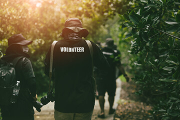 Volunteer working team walking survey in the forest for wildlife photography research and protection. - Powered by Adobe