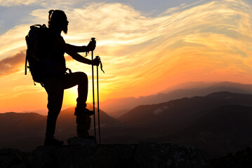 silhouette of mountain climber at sunset