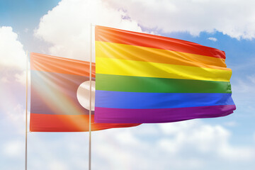 Sunny blue sky and flags of lgbt and laos