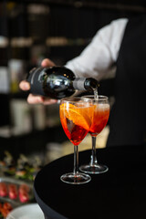 man bartender preparing Classic Italian Aperol Spritz cocktail