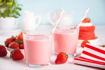 Glasses of strawberry milkshake or smoothie. Summer healthy vitamin beverage, diet or vegan food