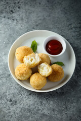 Traditional homemade arancini balls with tomato sauce	