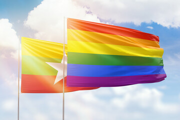 Sunny blue sky and flags of lgbt and myanmar